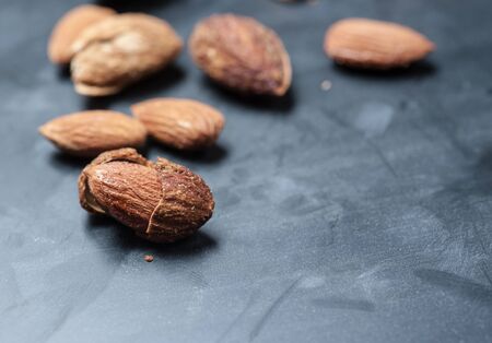 Almonds on a black slate background, shallow focusの写真素材