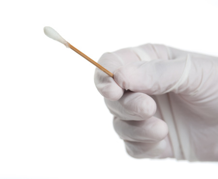 Hand with medical gloves holding cotton bud isolated on white background