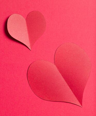 Red paper heart on red paperの写真素材