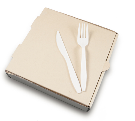 Blank pizza box with Plastic knife and fork isolated on white backgroundの写真素材