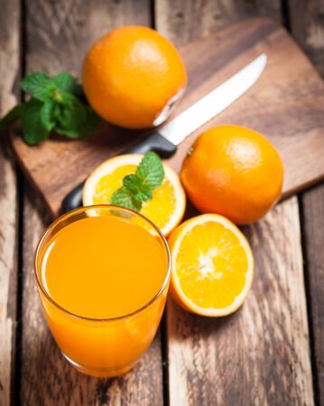 Fresh fruits Orange juice in glass on wood,Selective focus on glassの写真素材