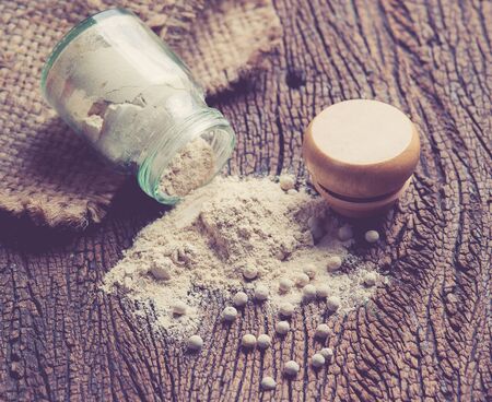 White pepper grain and powder isolated on white backgroundの写真素材