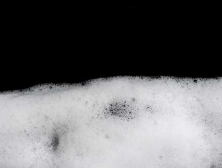 Foam bubbles abstract black backgroundの写真素材