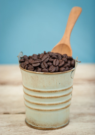 Coffee beans in small tank on wood,vintage tone style,Selective focusの写真素材