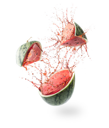 Sliced Watermelon and splash isolated on whiteの写真素材