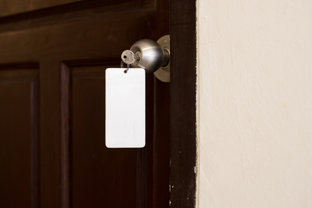 house key with hotel card and hotel doorの写真素材