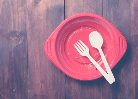 Empty dish after food on wood,top view,vintage color toned image