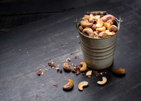 Roasted cashew nuts on  dark wood backgroundの写真素材
