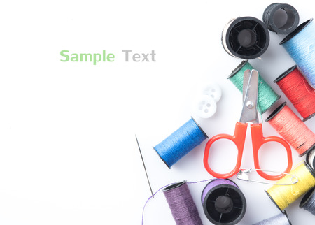 Sewing accessories,colorful spools of thread with scissors isolated on white background,top viewの写真素材