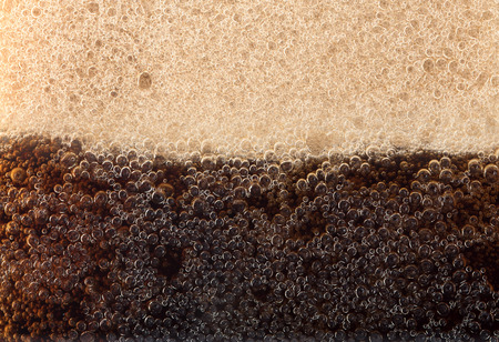 Macro black bubbles on the glass wall of colaの写真素材