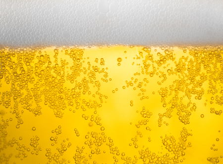 background beer and bubbles with condensation droplets on the outside of the glass