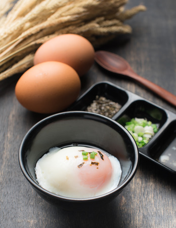 Soft boiled egg or onsen egg on woodenの写真素材