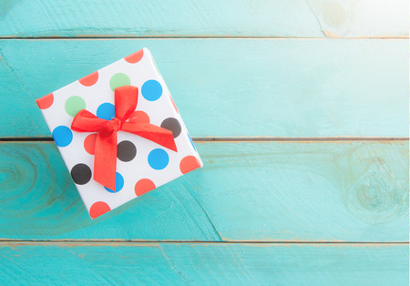 gift box with bow on blue wooden with space for text,top viewの写真素材