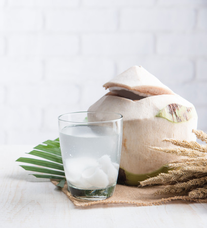 Coconut juice,Drink coconut water on table against white brick wallの写真素材