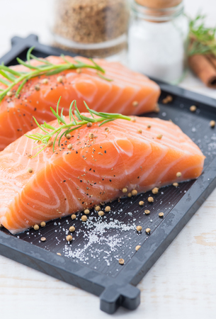 Sliced raw salmon on wood backgroundの写真素材