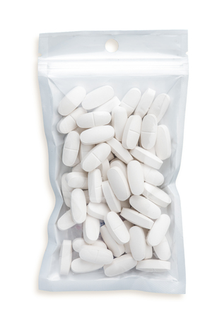 pills in plastic bag on white background.Medical concept.の写真素材