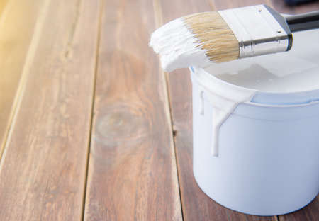 Paint bucket with paint brush on the old wooden background with copy spaceの写真素材