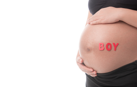 Belly of a pregnant woman with the word " BOY " isolated on white backgroundの写真素材