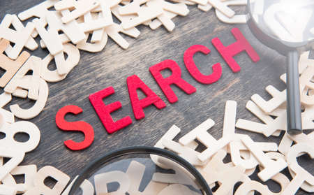 SEARCH word made from wooden letters with magnifying glassの写真素材