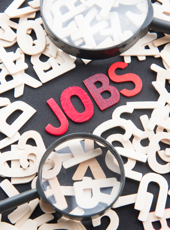 JOBS word made from wooden letters with magnifying glassの写真素材