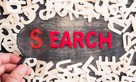 SEARCH word made from wooden letters with magnifying glassの写真素材