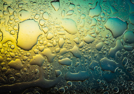 Complementary colors oil drops and water drops on glass,abstract background