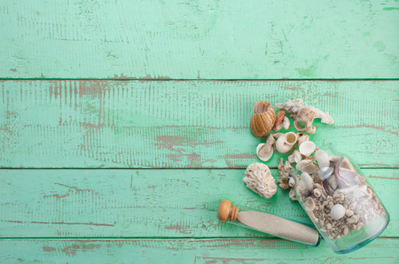 Summer background,Sand and seashells on wooden background