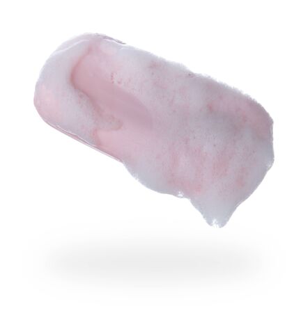 Piece of wet pink soap with foam on white backgroundの写真素材