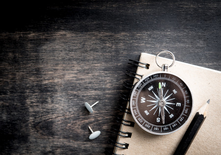 Compass and note book with space for text,top viewの写真素材
