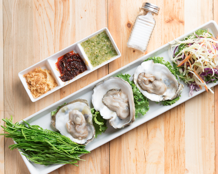 Fresh oysters with chili paste, seafood sauce, and deep fried red onion,Thai styleの写真素材