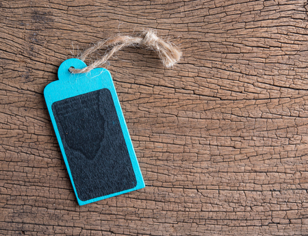 Wooden chalkboard price tag on wood table for text