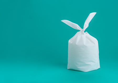 White plastic bag on green mint backgroundの写真素材