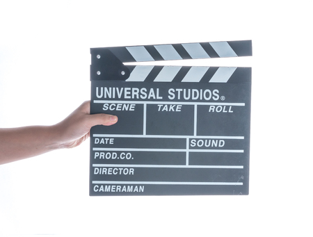 Woman holding movie production clapper board isolated on a white backgroundの写真素材