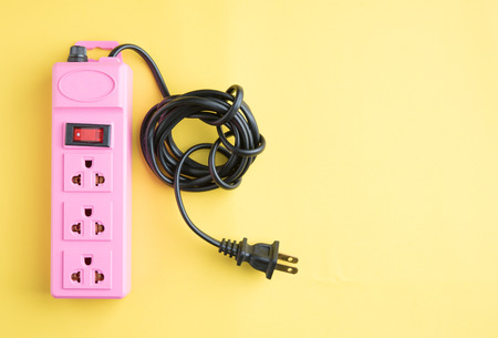Power plug socket on yellow backgroundの写真素材