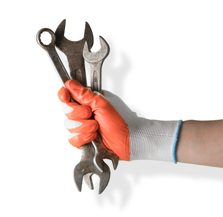 Handyman hand with glove holding wrenchs on white backgroundの写真素材