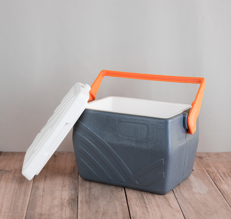 Handheld grey refrigerator on wood backgroundの写真素材