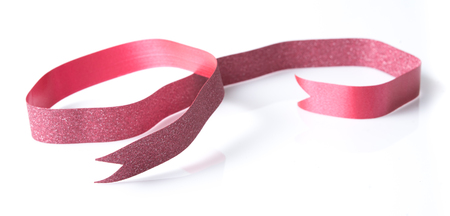 Red ribbon on a white background.の写真素材