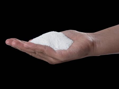 Washing powder on hand over dark backgroundの写真素材