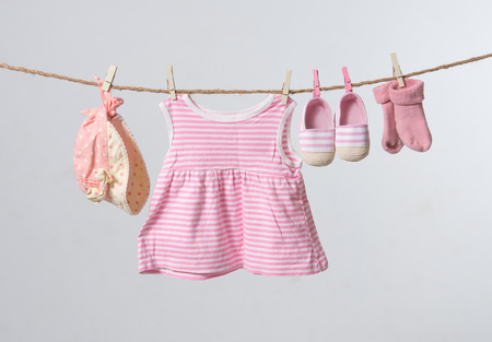 Baby goods hanging on a rope,gray backgroundの写真素材