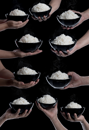Collection of hand holding bowl with cooked rice on black backgroundの写真素材