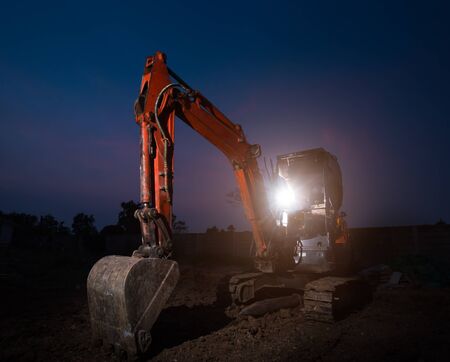 Backhoe did excavation at construction site,twilight timeの写真素材