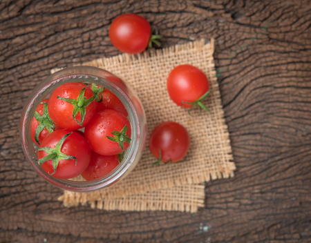 Mini tomatoes,cherry tomatoes on woodの写真素材
