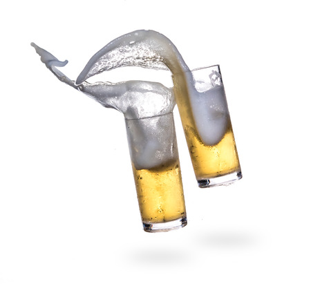 Beer splashing from glass isolated on white backgroundの写真素材