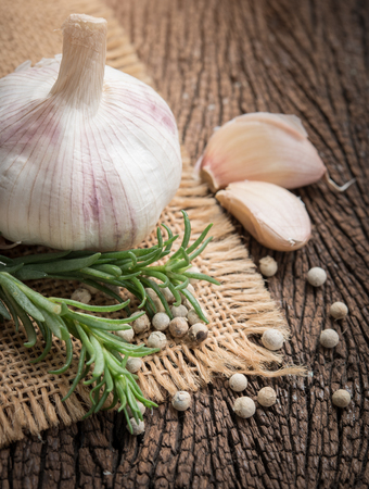 Garlic,rosemary and pepper on woodenの写真素材