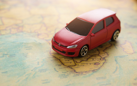 Travel and Transportation concept,Red miniature car on the mapの写真素材