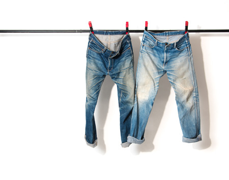 Blue Jeans hanging on clothesline,white backgroundの写真素材