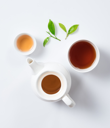 Tea concept,Teapot and cup of herbal tea with green tea leaves,top viewの写真素材