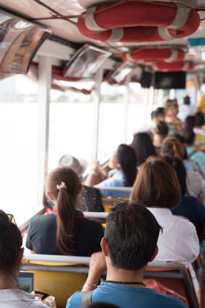 Thai people and tourists on ferryboat in the Chao Phraya riverの写真素材