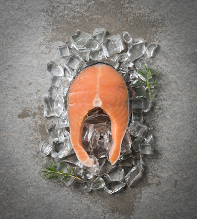 Fresh raw salmon steak on iceの写真素材
