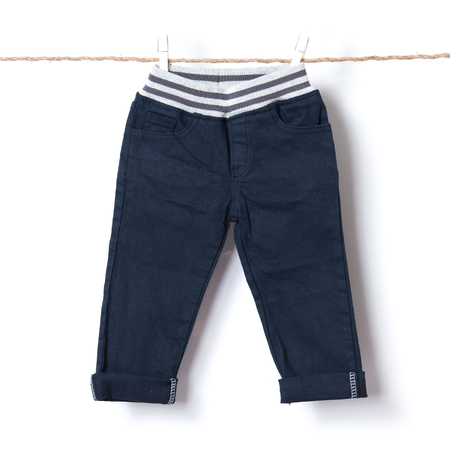 Baby boy pants hanging on the clothesline against white backgroundの写真素材